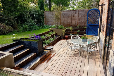 Design ideas for a small contemporary back full sun garden in Surrey with a water feature and decking.