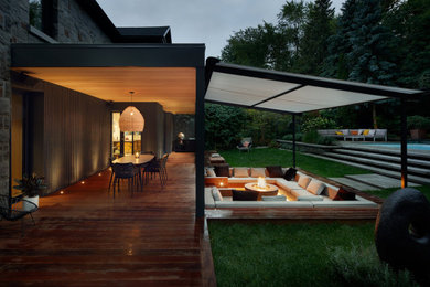 Design ideas for a contemporary partial sun backyard landscaping in Montreal.