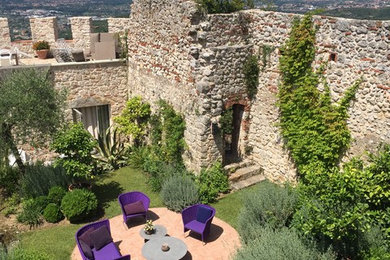Mediterranean Walled Garden With Bright Furniture