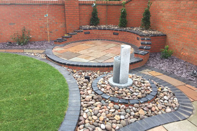 Inspiration for a medium sized contemporary back garden in Other with brick paving.