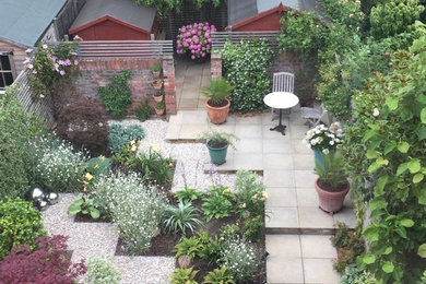 Design ideas for a small contemporary back formal partial sun garden for summer in London with gravel.