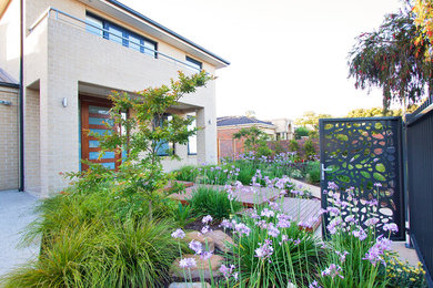 Imagen de jardín de secano bohemio grande en patio delantero con exposición total al sol y adoquines de piedra natural