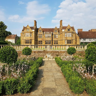 Design ideas for a classic formal garden in London with a garden path and concrete paving.