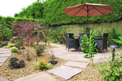 Photo of a medium sized back garden in Other with natural stone paving.
