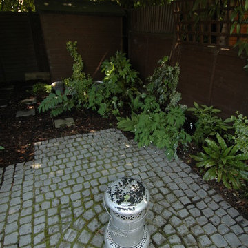 Outdoor burner on cobbled paving