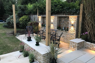 Design ideas for a medium sized contemporary garden in Surrey with brick paving.