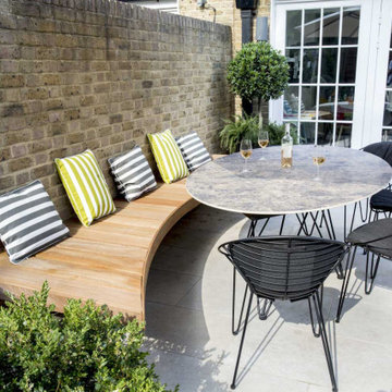 Patio dining area with table, chairs and suspended bench