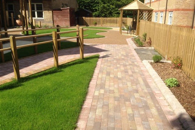 Photo of a medium sized traditional garden in Hampshire with concrete paving.