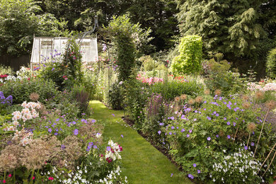 This is an example of a traditional back full sun garden for summer in Hampshire.