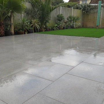 Porcelain/ Vitrified paved patio, paths with an artificial grass area.