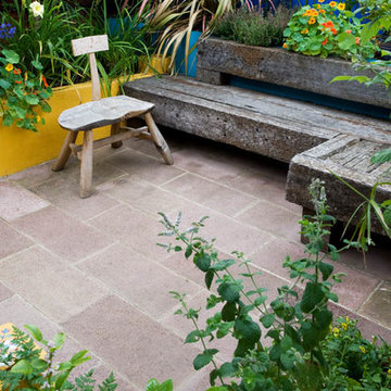Railway sleeper seating, rendered raised bed, terracotta sandstone paving