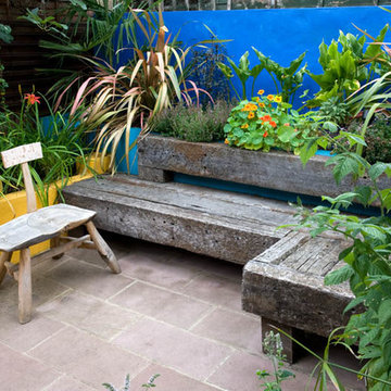 Railway sleeper seating, rendered raised bed, terracotta sandstone paving