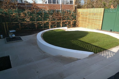Raised lawn with sawn mint sandstone paving