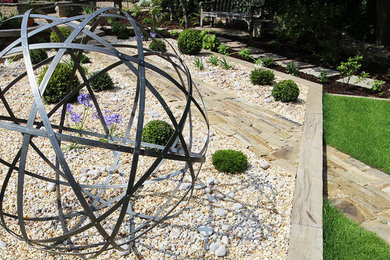 Photo of a large modern back formal partial sun garden for summer in Other with a water feature and gravel.