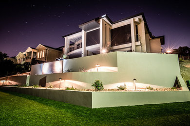 Photo of a mid-sized modern hillside retaining wall landscape in Adelaide.