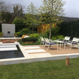 Inspiration for a medium sized contemporary formal garden in Gloucestershire with a waterfall.