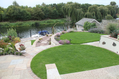 Medium sized contemporary back full sun garden for summer in Other with a water feature and natural stone paving.