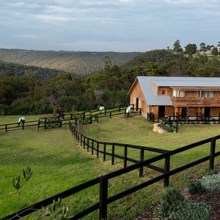 Country sloped full sun xeriscape in Sydney with brick pavers for spring.