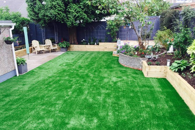 Design ideas for a medium sized contemporary back garden in Glasgow with natural stone paving.