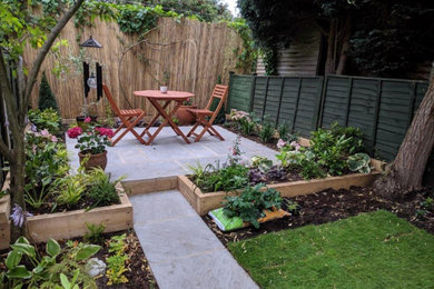 Small contemporary back formal and private fully shaded garden in Other with concrete paving.