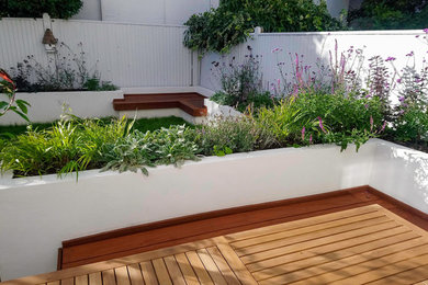 Design ideas for a small modern back full sun garden for summer in Kent with decking.