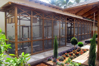 Exemple d'un grand jardin arrière chic avec une exposition ombragée et du gravier.