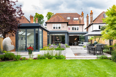 Design ideas for an expansive modern back formal full sun garden for summer in Surrey.