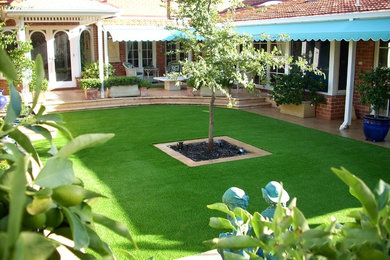 Diseño de jardín mediterráneo en patio trasero con jardín francés