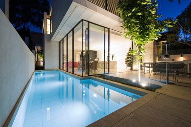 Contemporary side swimming pool in Melbourne with fencing.