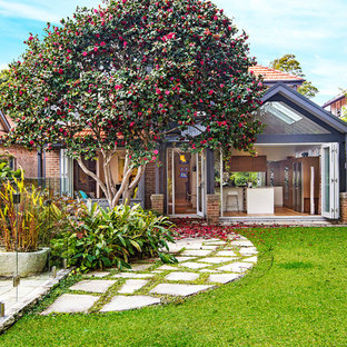 Traditional backyard garden in Sydney with natural stone pavers.
