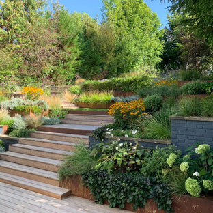 This is an example of a contemporary garden in London with a retaining wall and decking.