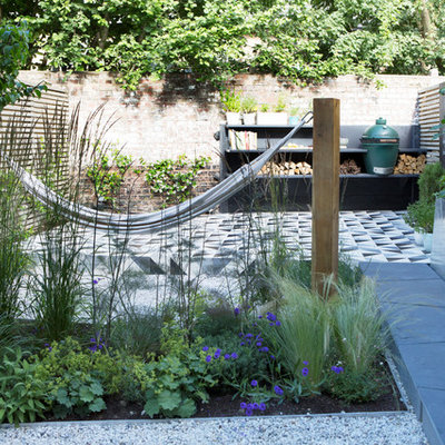 Photo of a small contemporary drought-tolerant and full sun backyard stone vegetable garden landscape in London for spring.