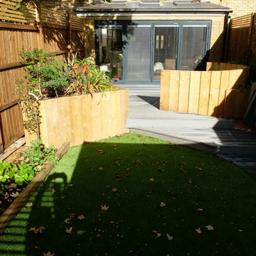 The finished garden with artificial grass, new fencing, raised beds and seating