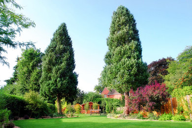 Photo of a large traditional back formal garden in Other with gravel.