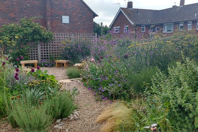 Small contemporary xeriscape full sun garden for summer in Sussex with gravel.