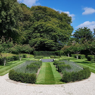 Photo of a traditional back formal garden in London with gravel.