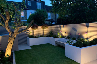 Inspiration for a small modern back partial sun garden in London with a raised bed.