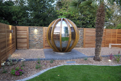 Large modern back full sun garden for summer in Other with natural stone paving.