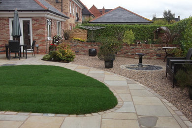This is an example of a medium sized contemporary back partial sun garden in Other with gravel.