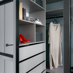 Inspiration för ett mellanstort funkis walk-in-closet för könsneutrala, med släta luckor, grå skåp, laminatgolv och beiget golv