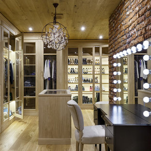 Foto di uno spazio per vestirsi unisex industriale con ante lisce, ante in legno chiaro, parquet chiaro e pavimento beige