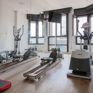 Ispirazione per una piccola palestra multiuso minimalista con pareti bianche e pavimento in legno massello medio