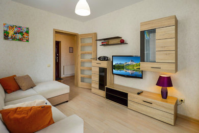 Идея дизайна: маленькая гостиная комната с бежевыми стенами, полом из ламината, телевизором на стене и бежевым полом для на участке и в саду