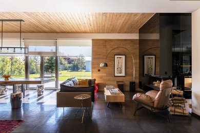 Immagine di un soggiorno design di medie dimensioni e aperto con pareti beige, pavimento con piastrelle in ceramica, camino ad angolo e pavimento nero