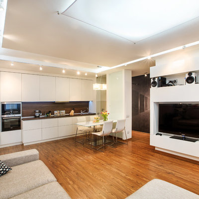 Trendy open concept medium tone wood floor living room photo in Moscow with white walls and a media wall