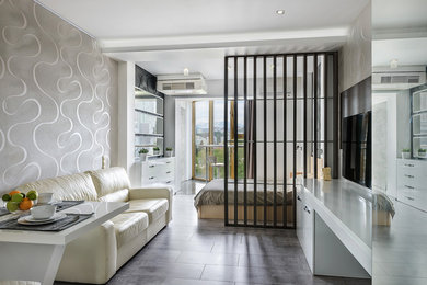 Источник вдохновения для домашнего уюта: парадная, открытая гостиная комната в современном стиле с серыми стенами, телевизором на стене и серым полом