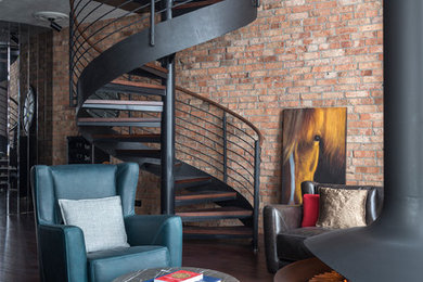 This is an example of an urban open plan living room in Moscow with dark hardwood flooring, a hanging fireplace, a metal fireplace surround, brown floors and brown walls.