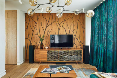 На фото: изолированная гостиная комната среднего размера в стиле фьюжн с с книжными шкафами и полками, бежевыми стенами, паркетным полом среднего тона, телевизором на стене, бежевым полом и панелями на части стены