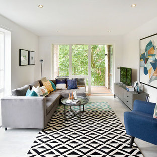 Photo of a contemporary games room in London with white walls, a freestanding tv and grey floors.
