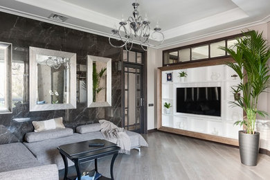 Идея дизайна: большая изолированная гостиная комната в стиле неоклассика (современная классика) с черными стенами, светлым паркетным полом, телевизором на стене и бежевым полом без камина